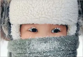  ?? Photos: REUTERS ?? Achild, with eyelashes covered with hoarfrost endures the weather in the eastern Siberian city of Yakutsk in Sakha (Yakutia) Republic.