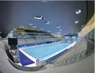  ?? TOBY MELVILLE/REUTERS ?? The London Aquatics Centre, built for the 2012 Olympics, is now bustles with children and recreation­al swimmers.