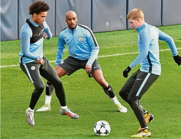  ?? — AFP ?? Three’s company: Kevin De Bruyne (right) training with Leroy Sane (left) and Fabian Delph at the City Football Academy in Manchester yesterday. City play Napoli in the Champions League today.