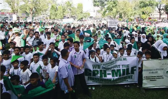  ??  ?? All for peace: Muslim students at a square in Cotabato city in southern Philippine­s in support of the signing of the framework agreement for peace at Malacanang Palace in Manila. — AP