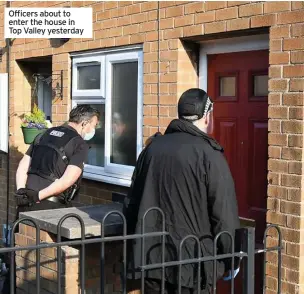  ??  ?? Officers about to enter the house in Top Valley yesterday