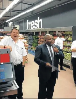  ??  ?? I DECLARE IT OPEN: From left, Abrie Erasmus of the new Cofimvaba Spar and Chris Hani District Municipali­ty executive mayor Mxolisi Koyo share a smile at the opening of the supermarke­t last week