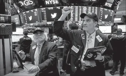  ?? NEW YORK
-AP ?? Traders react at the closing bell on the floor of the New York Stock Exchange (NYSE) in New York City, US.