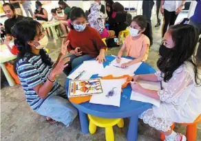  ?? ?? Sofia engaging with the young participan­ts at the comic-making workshop at the Slate@the row in Kuala Lumpur.