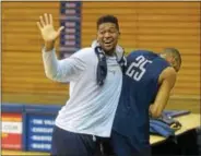  ?? PETE BANNAN — DIGITAL FIRST MEDIA ?? Villanova’s Kris Jenkins, left, jokes with Great Valley grad Mikal Bridges during practice at the Pavilion on Tuesday.