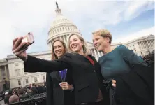  ?? Win McNamee / Getty Images ?? Democratic Reps. Mikie Sherrill (from left), Abigail Spanberger and Chrissy Houlahan take a selfie at the Capitol.