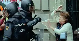  ??  ?? ‘SAVAGE’: Riot police confront a woman near a polling station last week