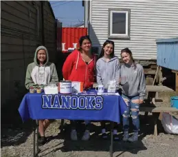  ?? Photo by Peter Loewi ?? MIZUKTATA—Alohna Johnson, Sophia Marble, Taylor Gorn, and Kara Johanson sell lemonade and cupcakes for the girl’s volleyball team during Mizuktata, Inupiaq for “Let’s drink juice.”