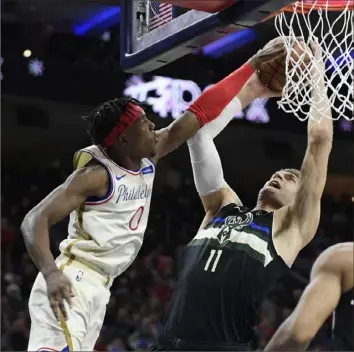  ?? Sarah Stier/Getty Images ?? Philadelph­ia’s Josh Richardson, left, blocks a shot by Milwaukee’s Brook Lopez Wednesday in Philadelph­ia. The 76ers defeated the Bucks — the team with the NBA’s best record — 121-109.