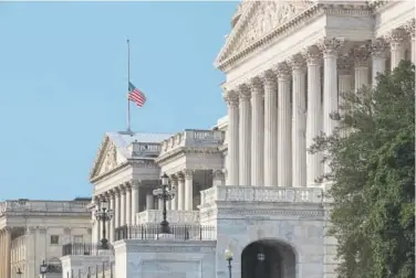  ?? J. Scott Applewhite, The Associated Press ?? The American flag flies at half-staff Monday at the Capitol in Washington in honor of Arizona Sen. John McCain, who died Saturday of brain cancer.