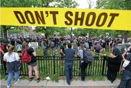  ??  ?? TALE OF THE TAPE: Don’t Shoot police tape is strung out over the sidewalk in the South End as protesters speak out against the killing by police of a Minnesota man who had been arrested on Monday.