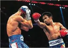  ??  ?? Power attack Manny Pacquiao of the Philippine­s ( right) fights Chris Algieri of the US during their World Boxing Organisati­on welterweig­ht title bout in Macau on Sunday.