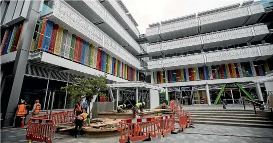  ?? PHOTOS: GEORGE HEARD/FAIRFAX NZ ?? Workers complete the finishing touches to the BNZ centre in Christchur­ch’s newly emerging city centre.