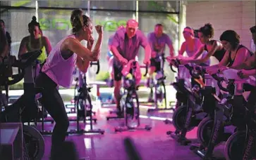  ?? Rev Cycle ?? DURING the shutdown, Peloton’s shares soared nearly 500% along with its sales. Now it will have more competitio­n as studios such as Rev Cycle, shown above before the pandemic, are allowed to resume indoor activity.