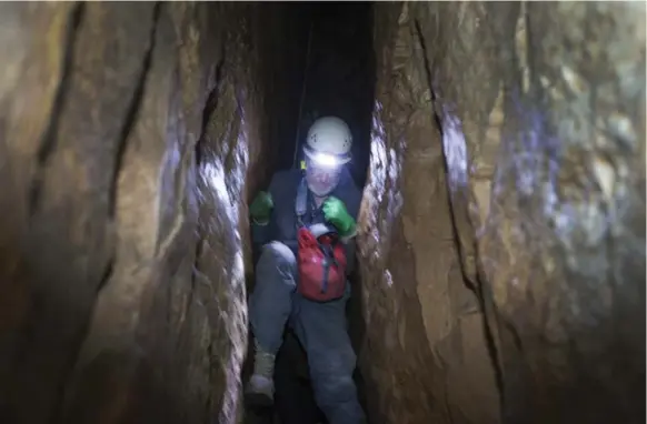  ?? PETER POWER FOR THE TORONTO STAR ?? Kirk MacGregor, president of the Toronto Caving Group, uses pressure from his elbows and knees to lower himself down a steep drop during a caving trip in Milton.