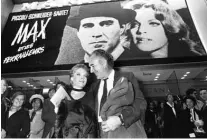  ??  ?? In this file photo taken on February 17, 1971, actors Michel Piccoli and Romy Schneider leave after the screening of “Max et les ferrailleu­rs” by Claude Sautet, in Paris.