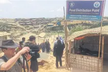  ??  ?? BELOW
Foreign journalist­s visit Kutupalong, the largest of the 23 refugee camps around Cox’s Bazar.