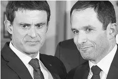  ??  ?? Hamon (right) looks on as he shakes hands with defeated candidate Manuel Valls (left) following the announceme­nt of the results of the second round of the left primaries ahead of France’s 2017 presidenti­al elections. — AFP photo