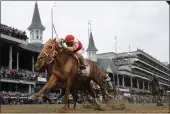  ?? JEFF ROBERSON — THE ASSOCIATED PRESS ?? Rich Strike, with Sonny Leon aboard, crosses the finish line to win the 148th running of the Kentucky Derby at Churchill Downs on Saturday in Louisville, Ky.