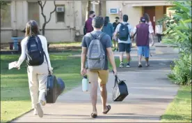  ??  ?? Baldwin High School students walk the campus on March 11