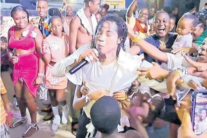  ?? CONTRIBUTE­D ?? Nixon Hall, the Jamaican Michael Jackson, is embraced by adoring fans as he performed at the Ocho Rios Seafood Festival in St Ann on Independen­ce Day.