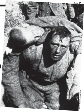  ?? Picture:IMPERIALWA­RMUSEUM ?? Under fire: A soldier carries a fallen comrade during the brutal Battle of the Somme