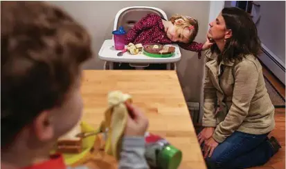  ?? Cheryl Senter / New York Times ?? Two-year-old Jane Sweet, who wears cochlear implants, with her mother, Laura, and brother, Henry, at home in Cumberland, Maine. Jane is among the 20,000 to 40,000 infants born with CMV every year.