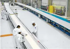  ?? ?? Employees working on blades for wind turbines produced.