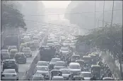  ?? MANISH SWARUP — THE ASSOCIATED PRESS ?? Commuters drive amidst morning haze and toxic smog in New Delhi, India, on Wednesday.