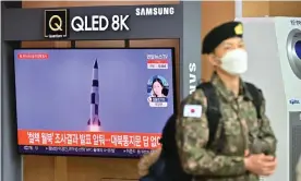  ?? Photograph: Jung Yeon-Je/AFP/ Getty Images ?? A South Korean soldier walks past a television news screen showing file footage of a North Korean missile test in Seoul after North Korea fired what appeared to be a ballistic missile into the sea off its east coast according to the South's military.