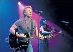  ?? David Becker / Getty Images ?? Recording artist Jon Bon Jovi, left, performs at an early vote event for Obama for America at the House of Blues inside the Mandalay Bay Resort & Casino on the last day Nevadans are able to register to vote Oct. 6, 2012 in Las Vegas, Nev.