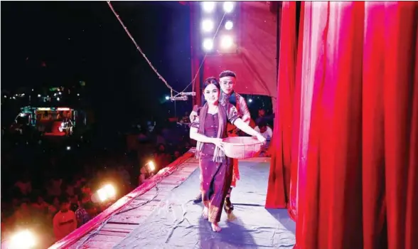  ?? HENG CHIVOAN ?? Soung Sokunthy (front) walks off the stage during a performanc­e of her play, ‘The Life of an Orphan’, in Takeo province.