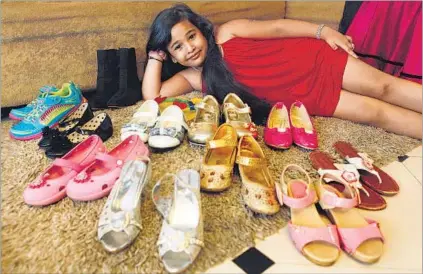  ?? ARIJIT SEN/HT ?? (Below) Ziya D’Souza, 6, poses with some of her shoes. At last count, she had 15 pairs of footwear, six bags, and a wardrobe that contained a number of net tops and gowns. ‘She loves to shop and has a big fetish for shoes and bags,’ says her mother, Esther, an entreprene­ur. Ziya was also among the models who walked the ramp at India Kids Fashion Week, in Mumbai.