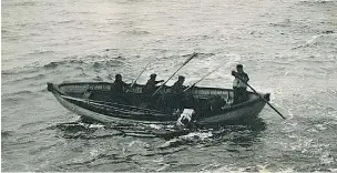  ??  ?? Crew members of the recovery ship CS Minia pull a lifebelted Titanic victim from the sea.