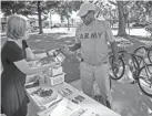  ??  ?? Angela Atkins, director of community ministry, gives a bike lock to Kevin Moore for his new bike.