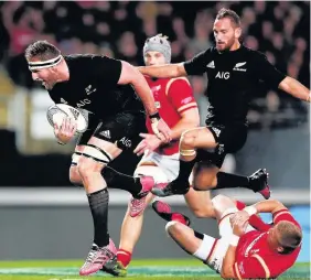  ??  ?? Kieran Read runs over Gareth Anscombe on his way to scoring the All Blacks’ fourth try