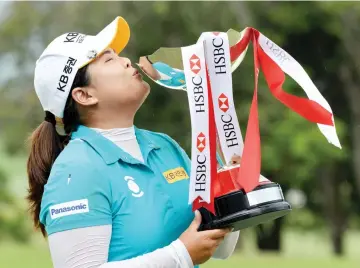  ??  ?? Park In-Bee of South Korea kisses the trophy after winning the HSBC Women’s Champions golf tournament at the Sentosa Golf Club in Singapore on March 5, 2017. - AFP photo