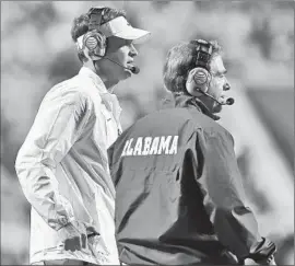  ?? Kevin C. Cox
Getty Images ?? LANE KIFFIN, left, did just fine in his first season as Alabama’s offensive coordinato­r under Nick Saban, right, but the Tide lost in the national semifinals.