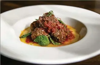  ?? CONTRIBUTE­D PHOTOS BY HENRI HOLLIS ?? Chef Adam Waller shares his recipe for Sal’s Meatballs, an appetizer on the menu at the forthcomin­g Bar Americano.