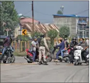  ?? (AP/Mukhtar Khan) ?? An Indian paramilita­ry soldier blocks a road Saturday in Srinagar in Indian-controlled Kashmir, which was under coronaviru­s restrictio­ns that prevented gatherings. More photos at arkansason­line.com/830kashmir/