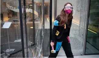  ?? ?? Five women from Extinction Rebellion are currently on trial for breaking glass at JPMorgan’s London HQ in 2021.