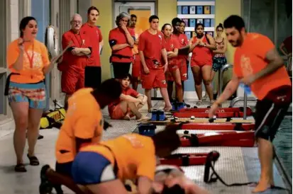  ?? JOHN TLUMACKI/GLOBE STAFF ?? YMCA lifeguards watched as the training staff demonstrat­ed a swimming pool rescue at the Waltham YMCA pool on Saturday.