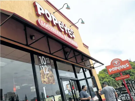  ?? JOE RAEDLE/GETTY IMAGES ?? A Popeyes restaurant is seen in Miami, Fla., on Tuesday. Burger King and Tim Horton’s owner Restaurant Brands Internatio­nal has announced plans to Popeyes Louisiana Kitchen in a deal valued at $1.8 billion US.
