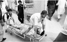  ??  ?? Injured being brought to a hospital in Quetta