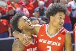  ?? MIKE SANDOVAL/FOR THE JOURNAL ?? UNM’s Donovan Dent, left, and Tru Washington celebrate after the Lobos defeated Boise State 76-66 in the quarterfin­als of the 2024 Mountain West Conference Tournament at the Thomas & Mack Center in Las Vegas.