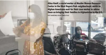  ?? PAT NABONG/SUN-TIMES FILE ?? Alina Hanif, a social worker at Muslim Women Resource Center in the West Rogers Park neighborho­od, works as Afghan Americans wait for their case worker to advise them on bringing their families in Afghanista­n to the U.S.