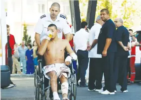  ?? (Reuters) ?? AN ISRAELI SURVIVOR of the Hezbollah bombing at Burgas, Bulgaria, on July 19, 2012, is wheeled to a waiting ambulance as he leaves the hospital.