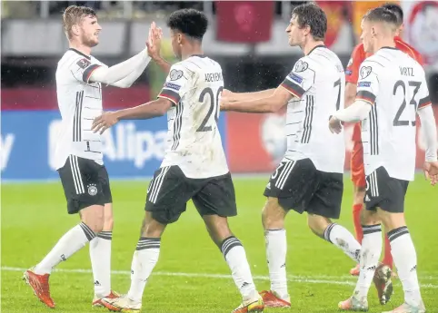  ?? AFP ?? Germany’s Timo Werner, left, celebrates with teammates after scoring against North Macedonia during their World Cup qualifier in Skopje.