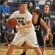  ?? BARRY TAGLIEBER - FOR DIGITAL FIRST MEDIA ?? Phoenixvil­le’s Dylan Clark looks to the basket as Pope John Paul II’s Vincent Viney defends.