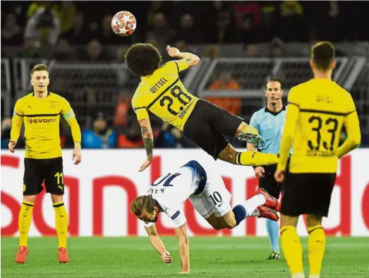  ?? — AP ?? C-r-a-s-h: Dortmund’s Axel Witsel (centre, top) clashes with Tottenham’s Harry Kane during the Champions League last-16 second-leg tie at the Signal Iduna Park in Dortmund on Tuesday.